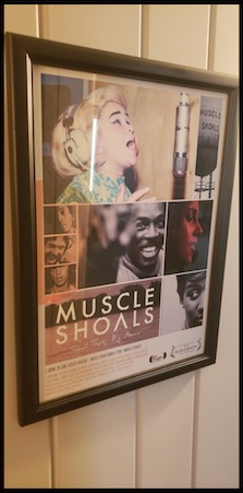 A framed poster of the movie Muscle Shoals